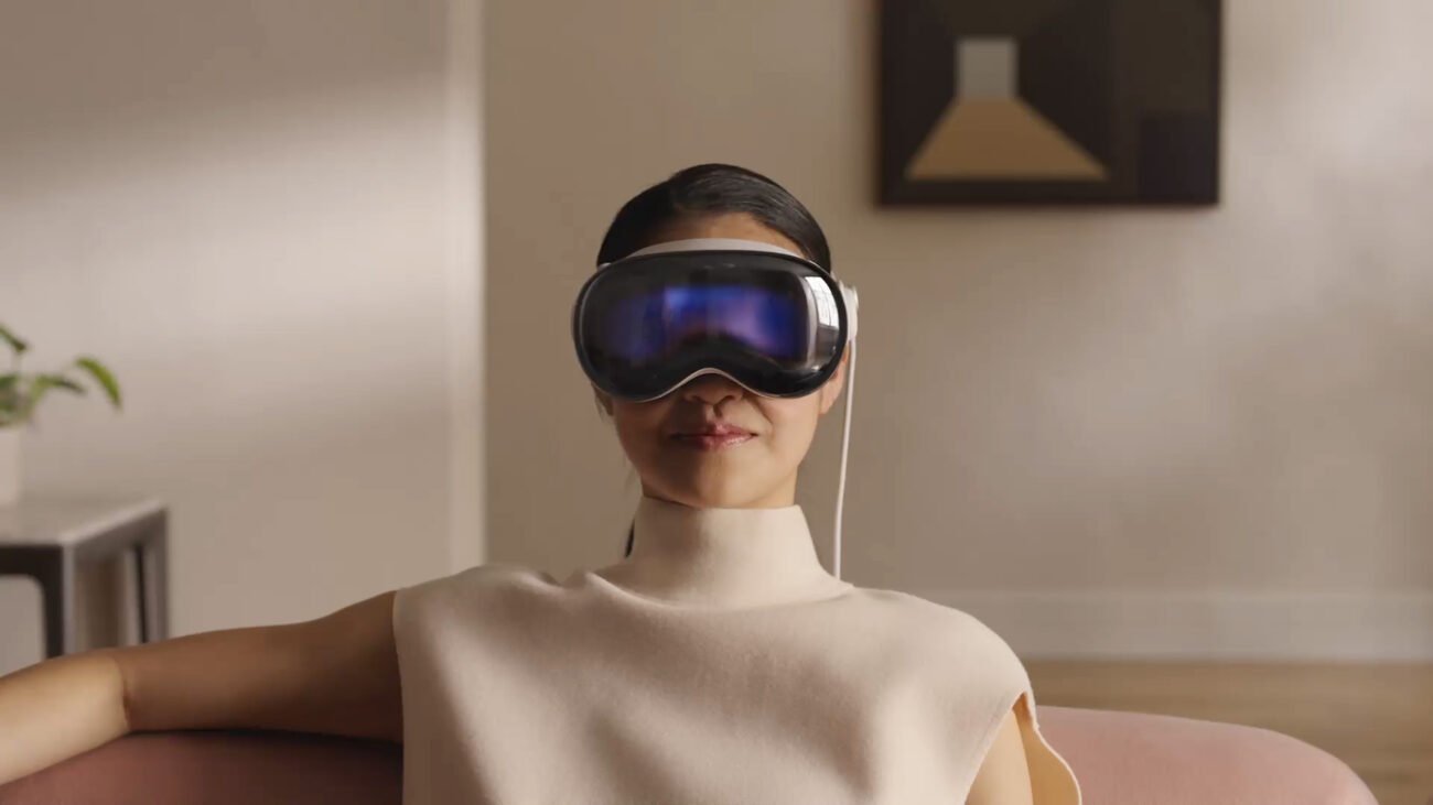 Woman experiencing Apple vision pro virtual reality headset indoors.